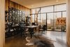 Modern home with Office, Study Room Type, Bookcase, Chair, Desk, and Concrete Floor. Home office opens up to a courtyard with a bubbling water fountain Photo 3 of Curves House