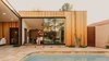 Modern home with Doors, Metal, Sliding Door Type, and Exterior. The doors of the master suite pocket behind the redwood to allow the space to extend to the pool courtyard Photo 10 of Curves House
