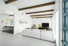 Modern home with Living Room, Sectional, Console Tables, Recliner, and Porcelain Tile Floor. Living room with the new wall opening to the kitchen beyond Photo 8 of Schreiber House