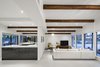 Modern home with Living Room, Recliner, Ceiling Lighting, Console Tables, Pendant Lighting, Floor Lighting, Porcelain Tile Floor, and Sectional. A focus of the renovation was to accentuate the original beams of the mid-century home Photo 6 of Schreiber House