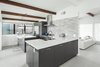 Modern home with Kitchen, Engineered Quartz Counter, Porcelain Tile Floor, Porcelain Tile Backsplashe, Ceiling Lighting, Pendant Lighting, Range, Range Hood, Refrigerator, and Undermount Sink. Kitchen Photo 3 of Schreiber House