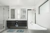 Modern home with Bath Room, Freestanding Tub, Ceiling Lighting, Porcelain Tile Floor, Vessel Sink, Engineered Quartz Counter, Enclosed Shower, Wall Lighting, Porcelain Tile Wall, and Two Piece Toilet. Master bathroom Photo 2 of Schreiber House