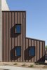 Modern home with Windows, Metal, and Casement Window Type. Custom Cor-Ten steel window boxes add shade to south facing windows Photo 8 of Uptown Row