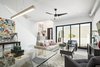 Modern home with Living Room, Sofa, Chair, Concrete Floor, and Ceiling Lighting. Sliding glass doors open up this living area to a private courtyard off of the pedestrian walkway Photo 6 of Uptown Row