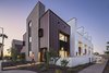 Modern home with Exterior, Apartment Building Type, Metal Siding Material, and Brick Siding Material. Uptown Row consists of 10 townhomes a mere 500 feet from a light rail station in Phoenix. Each unit has a semi-private courtyard behind a spaced block wall, and a private roof deck with view of the city skyline and mountains beyond Photo of Uptown Row