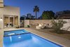 Modern home with Outdoor, Side Yard, Decomposed Granite Patio, Porch, Deck, Small Pools, Tubs, Shower, Desert, and Pavers Patio, Porch, Deck. Custom firepit and concrete bench off to the side of the pool and hot tub Photo 19 of Sol House