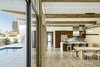 Modern home with Dining Room, Ceiling Lighting, Table, Bench, Pendant Lighting, and Porcelain Tile Floor. The wood beams flow from inside to outside and angle up to capture a view of the tallest tower in the area. Photo 9 of Sol House