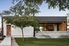 Modern home with Concrete Patio, Porch, Deck, Trees, Ceiling Lighting, Concrete Floor, Grass, Front Yard, and Outdoor. The front elevation is a modern distillation of the historic homes in the neighborhood, featuring the same composition of a protruded front volume with a single opening flanked by a shaded living area Photo 8 of Link House