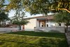 Modern home with Concrete Patio, Porch, Deck, Trees, Concrete Floor, Ceiling Lighting, Back Yard, Outdoor, and Grass. After 2.5 years, we went back to photograph how the house has matured over time. Time is something we try to incorporate into the design of our homes, through the use of specific materials and the form and layout of the home. Photo 7 of Link House