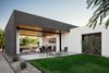 Modern home with Concrete Patio, Porch, Deck, Front Yard, Trees, Ceiling Lighting, Concrete Floor, Back Yard, Grass, Exterior, and Stucco Siding Material. A board formed concrete fire pit draws you out to the back patio from the open living space Photo 5 of Link House