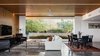 Modern home with Concrete Patio, Porch, Deck, Trees, Ceiling Lighting, Concrete Floor, Grass, Living Room, and Back Yard. Opening up the glass wall of the living space turns the neighborhood into a constantly changing piece of art Photo 6 of Link House