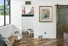 Modern home with Kids Room, Playroom, Bench, Medium Hardwood Floor, Toddler Age, Pre-Teen Age, and Neutral Gender. Kid's nook features a hidden brass ladder up to a lucite enclosed play space. Reclaimed brass door hides toy storage Photo 4 of Modern Manor