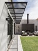 Modern home with Outdoor, Desert, and Grass. Custom cut steel awning. The awning design uses the archetypal gable shape of the house and rotates it to create the perforated pattern Photo 5 of Canal House
