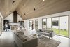 Modern home with Living Room, Ceiling Lighting, Coffee Tables, Sofa, and Concrete Floor. Great room with vaulted ceiling and flooded with natural light from the north and south Photo 12 of Canal House