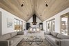 Modern home with Living Room, Ceiling Lighting, Pendant Lighting, Coffee Tables, and Sofa. The great room is highlighted by a rusted metal custom hood at the end of the space, with courtyards on both sides Photo 10 of Canal House