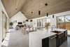 Modern home with Kitchen, Microwave, Concrete Floor, Engineered Quartz Counter, Undermount Sink, and Dishwasher. View from the kitchen to the dining and living room beyond Photo 6 of Canal House