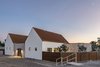 Modern home with Outdoor, Desert, Horizontal Fences, Wall, and Metal Fences, Wall. Front view at twilight Photo 3 of Canal House