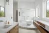 Modern home with Bath Room, Undermount Sink, Engineered Quartz Counter, Freestanding Tub, Enclosed Shower, Marble Floor, Marble Wall, Wall Lighting, and Full Shower. Both vanities with freestanding tub and steam shower in the background Photo 5 of Cliff House