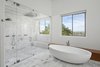 Modern home with Bath Room, Undermount Sink, Freestanding Tub, Engineered Quartz Counter, Marble Floor, Marble Wall, Enclosed Shower, and Ceiling Lighting. Freestanding tub and Steam Shower with views of downtown Phoenix Photo of Cliff House