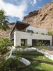 Modern home with Exterior, House Building Type, Stone Siding Material, and Flat RoofLine. The roof of the new 2nd story addition soars above the new limestone clad entry Photo 2 of Red Rocks