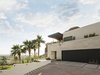 Modern home with Garage and Attached Garage Room Type. Above the new entry, custom planters hidden behind the limestone cladding spill vegetation over the wall Photo 3 of Red Rocks