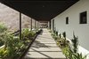 Modern home with Outdoor, Decomposed Granite Patio, Porch, Deck, Walkways, Hardscapes, Desert, Front Yard, Landscape Lighting, Concrete Patio, Porch, Deck, Small Pools, Tubs, Shower, and Large Patio, Porch, Deck. Entry walkway leading to the front door and eventually to the grill and down to the pool Photo 8 of Red Rocks