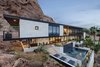 Modern home with Exterior, Flat RoofLine, Stone Siding Material, and House Building Type. The new 2nd story front addition added an extra en-suite bedroom as well as 2000 square feet of covered patios that extend out towards desert and city views Photo 11 of Red Rocks