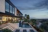 Modern home with Outdoor, Concrete Patio, Porch, Deck, Front Yard, Infinity Pools, Tubs, Shower, Landscape Lighting, Decomposed Granite Patio, Porch, Deck, Small Pools, Tubs, Shower, Desert, and Large Patio, Porch, Deck. A new hot tub, firepit and pool pull the homeowners out towards the view at all times of the year Photo 12 of Red Rocks