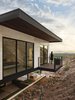 Modern home with Exterior, Stone Siding Material, House Building Type, and Flat RoofLine. A modern take on the "Juliet Balcony" cantilevers over the mountain to provide an opportunity to step out and take in the Phoenix skyline at sunset Photo 14 of Red Rocks