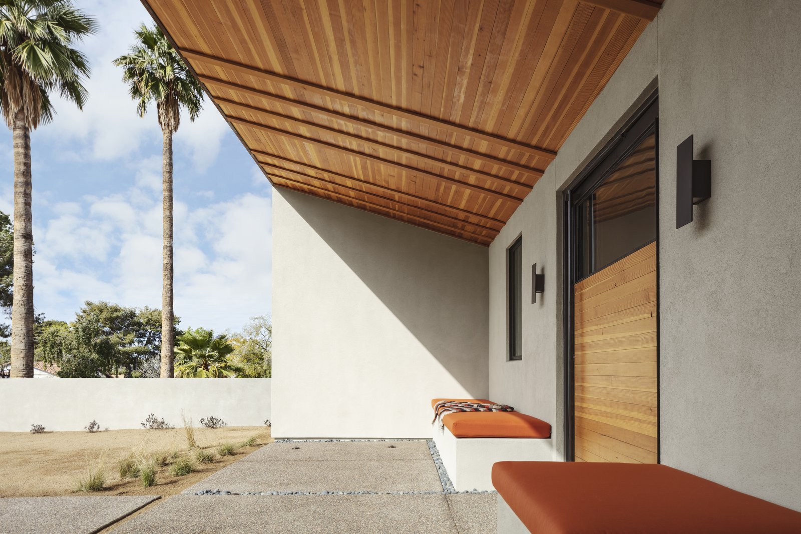 The covered entry, like the rest of the house, focuses on line, color and composition, using simple materials, distinctive geometries and the desert sky