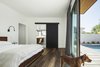 Modern home with Recessed Lighting. Wood floors and a matte black barn door in the master bedroom bring some of the exterior finishes into the house Photo 16 of Pleats