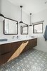Modern home with Pendant Lighting. The master bathroom features cement tile with a wall hung, walnut vanity with a white quartz counter top. Rounded edge, square mirrors and matte black pendant lights finish off the look Photo 17 of Pleats