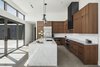 Modern home with Concrete Floor, Pendant Lighting, and Recessed Lighting. Walnut cabinets, a black metal clad hood and a combination of stainless steel and marble counter tops make up the material palette of the kitchen Photo 14 of Pleats