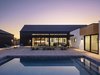 Modern home with Exterior, Flat RoofLine, House Building Type, Metal Siding Material, Gable RoofLine, Stucco Siding Material, Wood Siding Material, and Metal Roof Material. The gabled volume of the house blocks the harsh, setting sun from the courtyard, creating the ideal space for enjoying the pool after work in the summer Photo 20 of Pleats