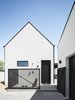 Modern home with Exterior, Gable RoofLine, House Building Type, Metal Roof Material, and Stucco Siding Material. An outdoor shower on the rear gable of the house is used for rinsing off from the pool or after an outdoor excursion, or for a quick wash down for their two rescue dogs Photo 6 of Pleats