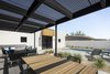 Modern home with Outdoor, Hardscapes, Small Patio, Porch, Deck, Desert, Small Pools, Tubs, Shower, Pavers Patio, Porch, Deck, and Back Yard. A perforated, corrugated metal patio cover provides a transition between the bright desert sun, and the shaded interior of the house Photo 9 of Pleats