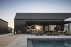 Modern home with Exterior, House Building Type, Metal Roof Material, Gable RoofLine, and Metal Siding Material. The last glimpse of sunlight in the pool courtyard Photo 19 of Pleats