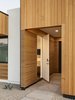 Modern home with Exterior, Wood Siding Material, House Building Type, Stucco Siding Material, Metal Roof Material, Flat RoofLine, and Gable RoofLine. A disguised door for guests Photo 4 of Pleats