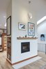 Modern home with Living Room, Light Hardwood Floor, Wood Burning Fireplace, Pendant Lighting, Recessed Lighting, and Bookcase. Wood Burning Fireplace Photo of Selby Residence