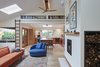 Modern home with Living Room, Chair, Bookcase, Sofa, Pendant Lighting, Ceiling Lighting, Recessed Lighting, Light Hardwood Floor, and Wood Burning Fireplace. Living Room + Kitchen Photo 2 of Selby Residence
