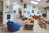 Modern home with Living Room, Chair, Ottomans, End Tables, Sofa, Pendant Lighting, Light Hardwood Floor, and Wood Burning Fireplace. Living Photo 7 of Selby Residence