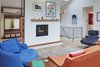 Modern home with Living Room, Wood Burning Fireplace, Light Hardwood Floor, Ottomans, Chair, Sofa, and Pendant Lighting. Living Room Photo 3 of Selby Residence