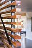 Modern home with Hallway and Dark Hardwood Floor. The entry/stair screen wall is made of fir timber that was slipped over steel posts and sits on a custom made bracket. Photo 4 of Ranger’s Ridge