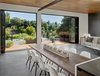 Modern home with Dining Room, Table, and Chair. The foldings doors are by La Cantina, which expand to a redwood deck and the view across the valley. Photo 6 of Trestle Glen Modern