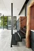 Modern home with Staircase, Metal Tread, and Metal Railing. The burled redwood slab from Aborica serves as a dramatic portal as you descend into the lower zone of the Escape Pad. The custom partition housing the tub and powder room area lie beyond. The custom metal works was by Metropolis Metalworks. Photo 6 of Twin Peaks Escape Pad