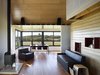Modern home with Living Room, Wood Burning Fireplace, Chair, Sofa, and Medium Hardwood Floor. Yum Yum Farm in Iowa Photo 9 of Yum Yum Farm