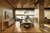 Modern home with Dining Room, Table, Chair, Two-Sided Fireplace, Concrete Floor, and Ceiling Lighting. Dining Room with view through sliding doors of terrace and tea house Photo of Union Bay Residence