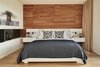 Modern home with Bedroom, Bed, Night Stands, and Medium Hardwood Floor. Master Bedroom with teak wall and custom fireplace Photo 7 of Union Bay Residence