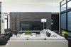 Modern home with Living Room, Medium Hardwood Floor, Sectional, and Standard Layout Fireplace. Living room w multi-purpose storage wall Photo 6 of High Desert Modern