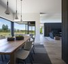 Modern home with Dining Room, Light Hardwood Floor, Pendant Lighting, Chair, and Table. Dining room w view toward living and master bedroom Photo 9 of High Desert Modern